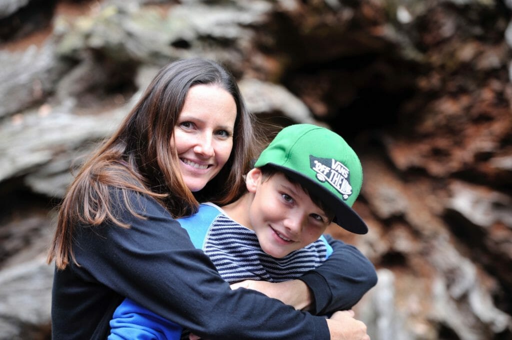 Care provider and boy hugging